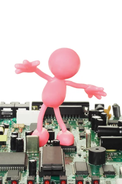 Figurinha de borracha jogando na placa de circuito eletrônico — Fotografia de Stock