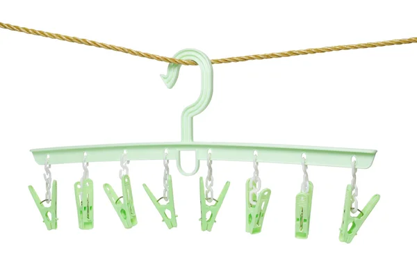 Plastic clothes hanger with hanging pegs — Stock Photo, Image