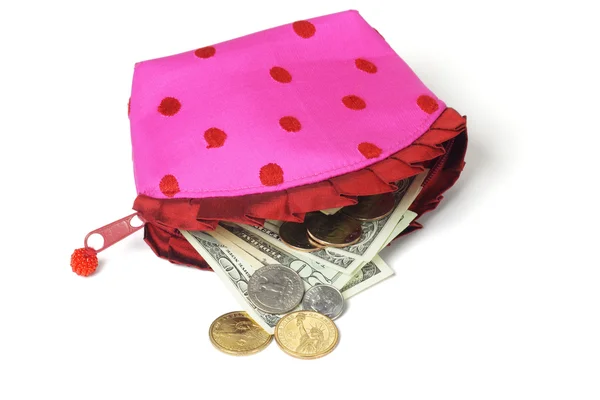 US notes and coins spilling out from pink purse — Stock Photo, Image
