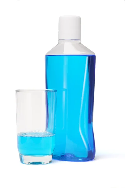 Plastic bottle and glass of mouthwash — Stok fotoğraf