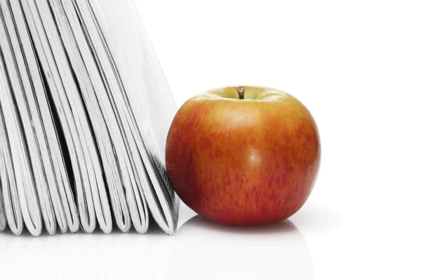 Red apple beside pile of school workbooks — Stock Photo, Image
