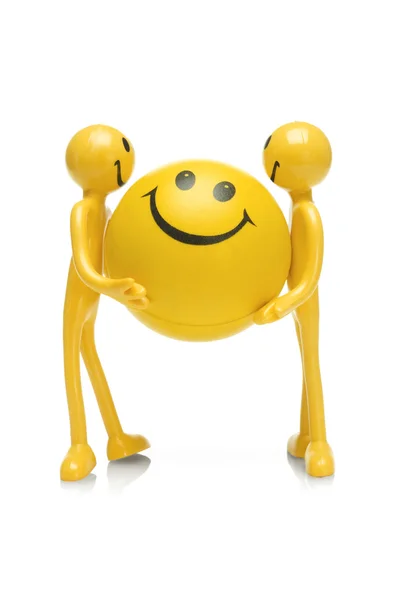 Smiley figurines holding smiley ball — Stock Photo, Image