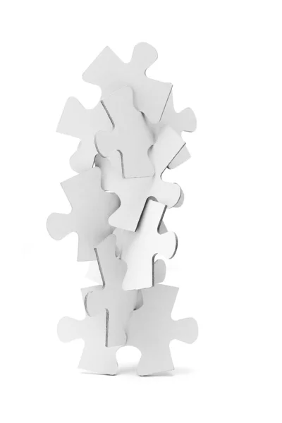 Interlocking pieces of jigsaw puzzles tower — Stock Photo, Image