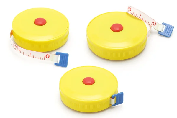 Drie gele plastic meten tapes — Stockfoto