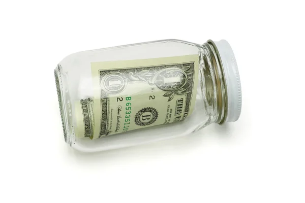 Один доллар США в стеклянной банке — стоковое фото