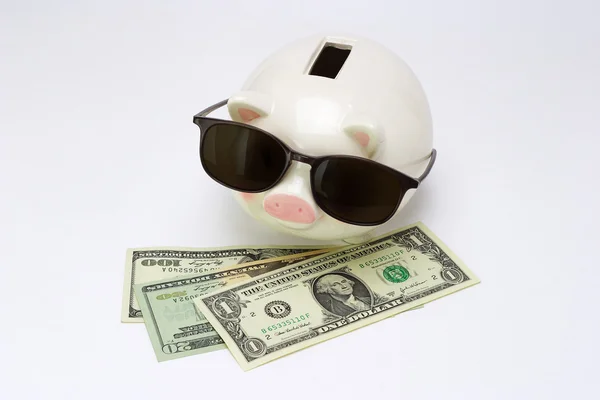 Blind piggy bank and US dollars — Stock Photo, Image