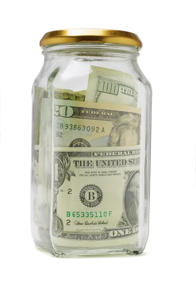 Bobines en dollars américains dans un récipient en verre — Photo