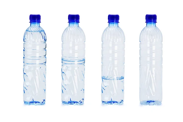Plastic bottles with different water levels inside — Stock Photo, Image