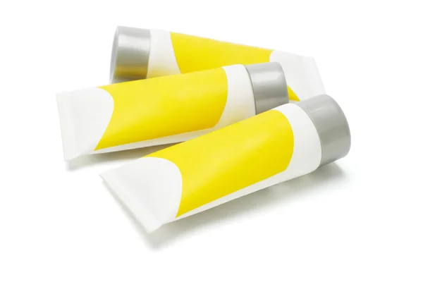 Tres tubos con etiquetas amarillas — Foto de Stock