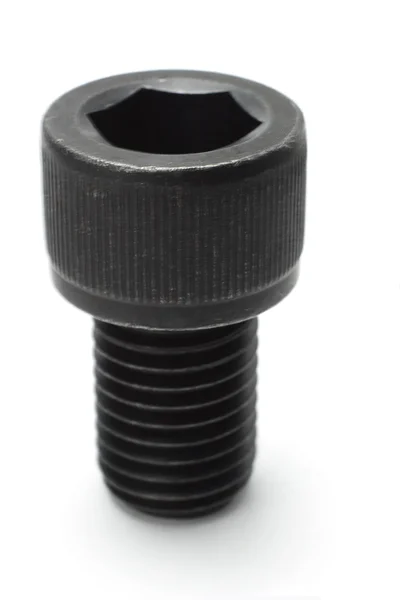 Black hexagonal metal bolt — Stock Photo, Image