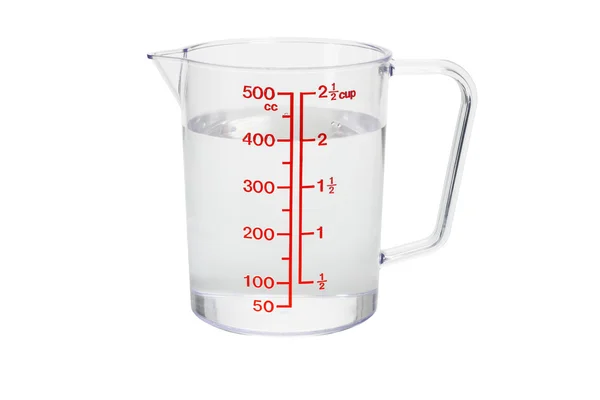 Plastic kitchen measuring cup filled with water — Stock Photo, Image