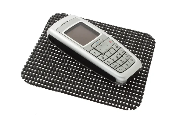 Teléfono móvil en alfombra antideslizante — Foto de Stock