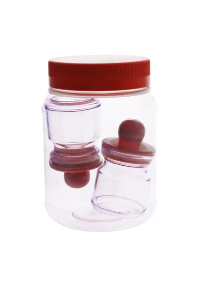 Mini empty condiment containers inside plastic jar — Stock Photo, Image