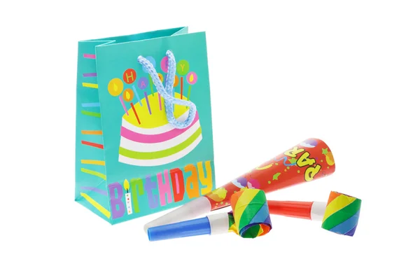 Colorful gift bag and party blowers — Stock Photo, Image