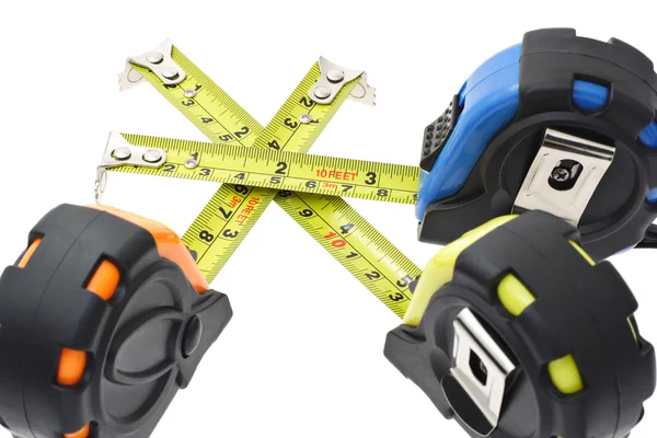Measuring tapes criss crossing each other — Stock Photo, Image