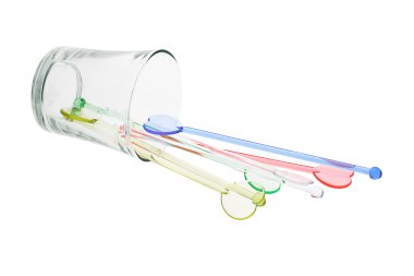 Color plastic swizzle sticks spilled from glass clipart