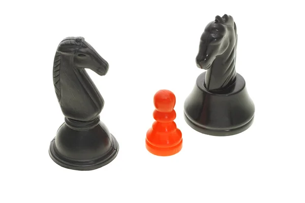 Two black knights and a red pawn — Stock Fotó