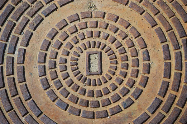Iron manhole in the street - colse up — Stock Photo, Image