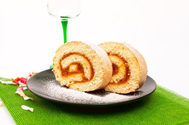 Rolled sponge cake fiiled with jam clipart