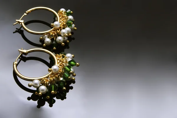 Handmade earrings with gemstones over black background — Stock Photo, Image