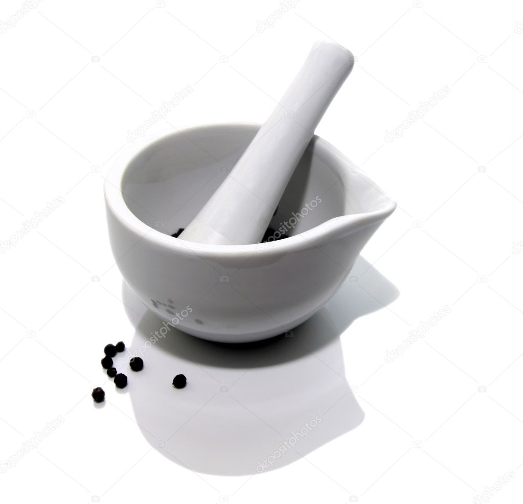 White mortar and pestle with black pepper on white background
