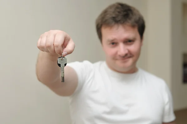 Portrait of a man holding the keys of his home — Stock Photo, Image