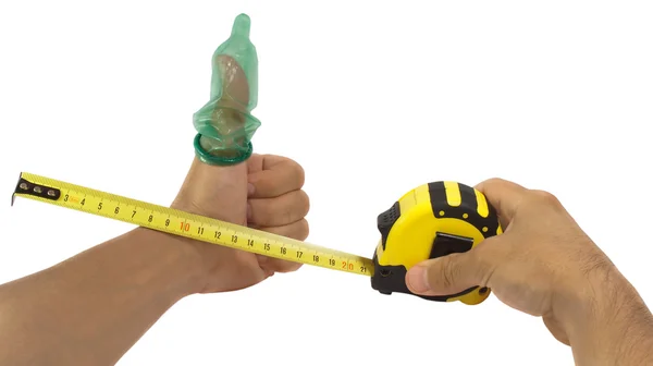 Hands with condom on finger and tape measure, isolated — Stock Photo, Image