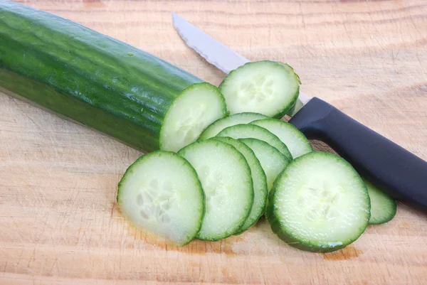 Cutting English cucumber slices — Stock Photo, Image