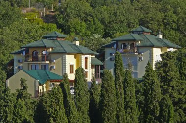 Two houses on the hillside clipart