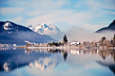 Mountain lake in Alps with scenic reflection clipart