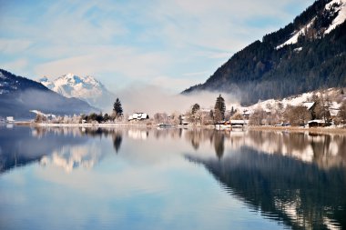 Mountain lake in Alps with scenic reflection clipart