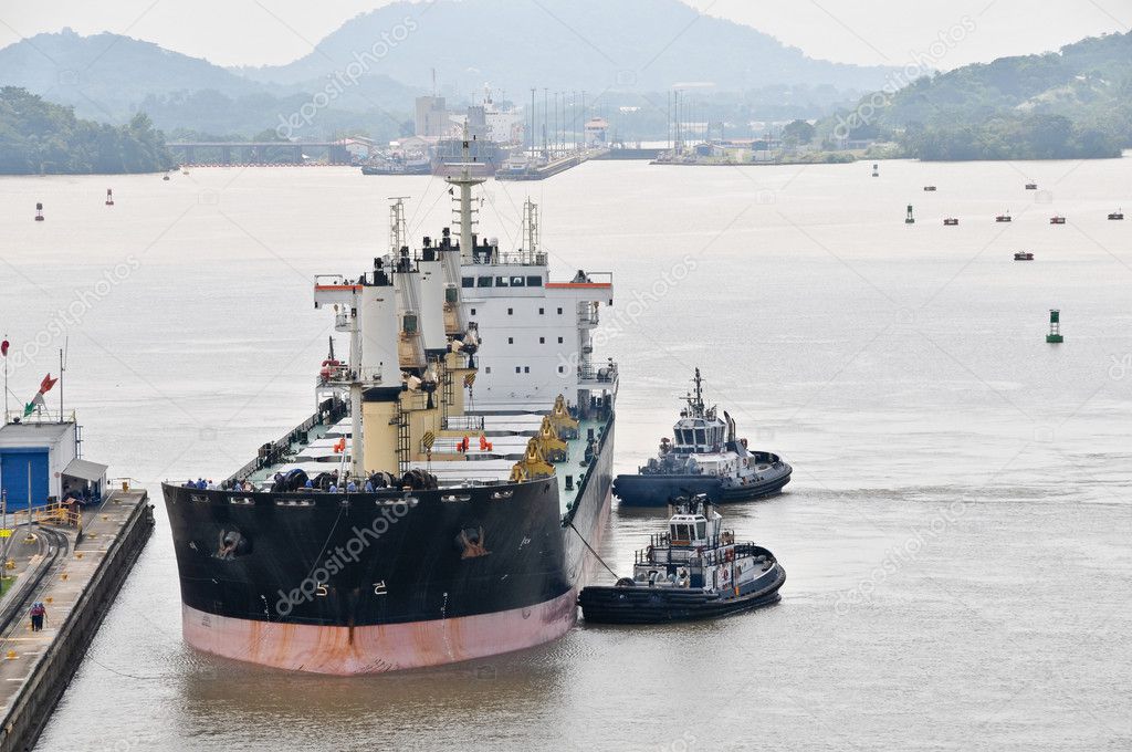 Tugboats pushing ship in the Panama Channel