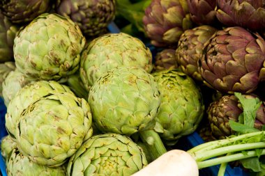 Freshly harvested artichokes on display at the farmers market clipart