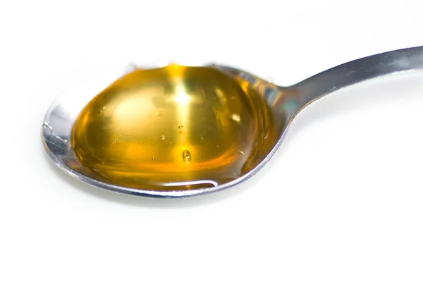 Miele che gocciola giù sul cucchiaio — Foto Stock