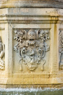 Isolated sculpture on fountain at st peter square, vatican clipart