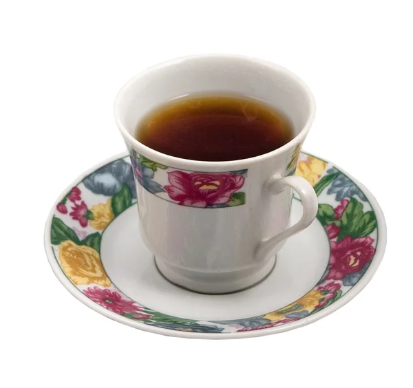 Cup of very strong tea with flowers at the saucer. — Stock Photo, Image