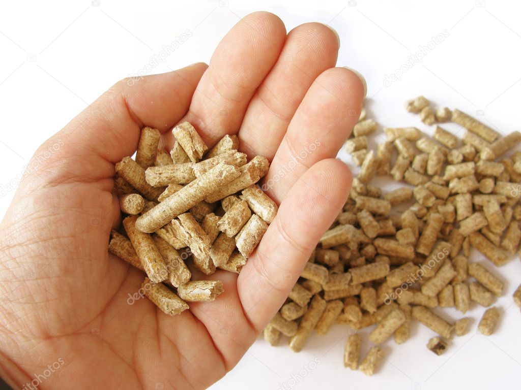 A hand picking wood pellets