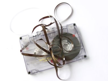 An old damaged cassette tape, isolated in white clipart