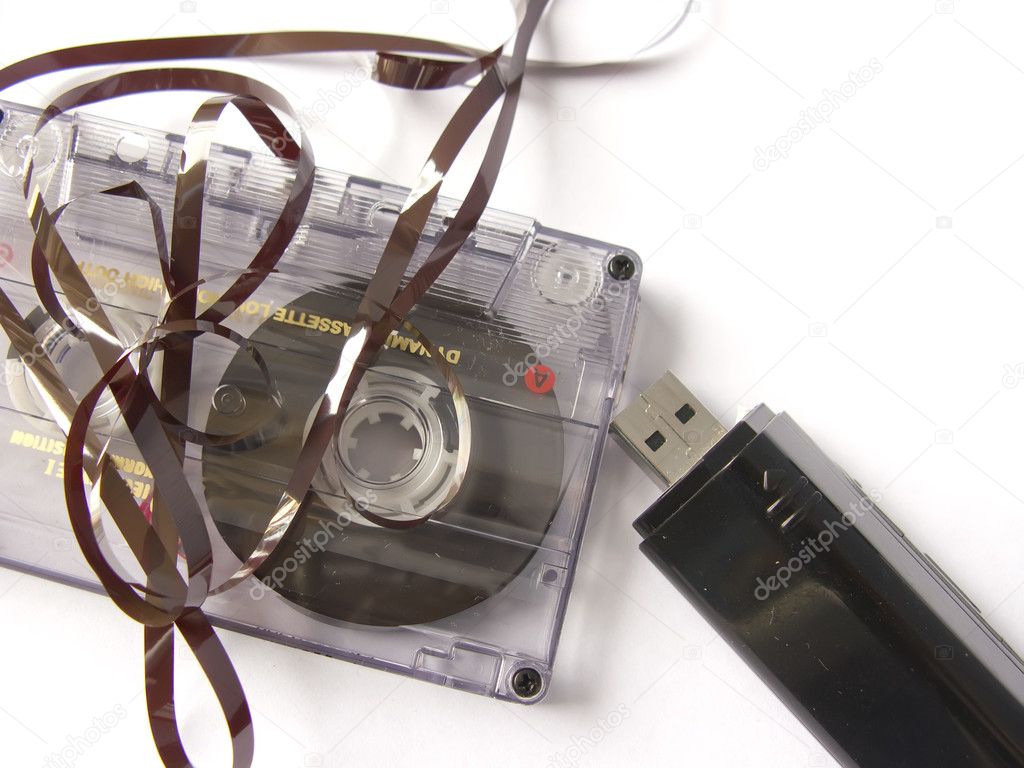 An old damaged cassette tape, versus a mp3 pen drive. New versus old techno