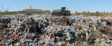 The bulldozer on a garbage dump clipart