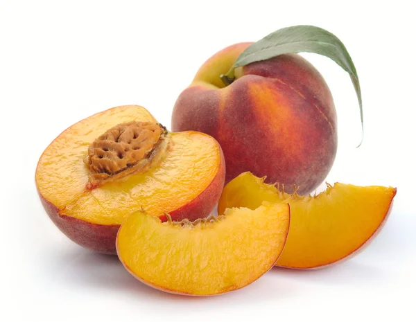 Peach and a half and leaves — Stock Photo, Image