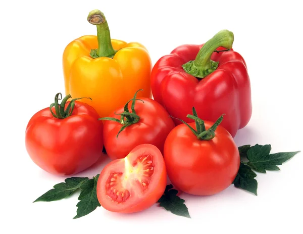 Tomatoes and peppers with leaves — Stock Photo, Image