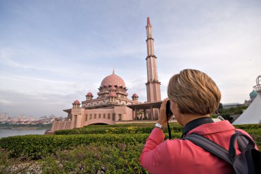 Tourist taking photo of Putra Mosque in Putrajaya, Selangor, Malaysia clipart