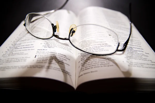 stock image Bible opened with reading glasses