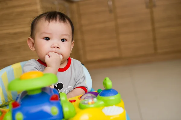 6 month old Asian baby girl chewing her fingers — Stock Photo, Image