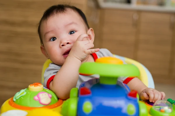 6 month old Asian baby girl chewing her fingers — Stock Photo, Image
