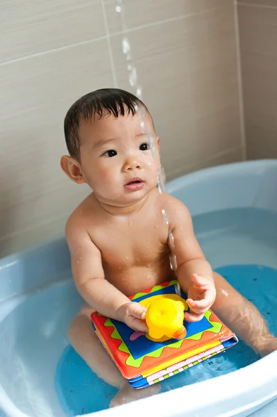 stock image 8 month old Asian baby girl having fun playing with water during her bath