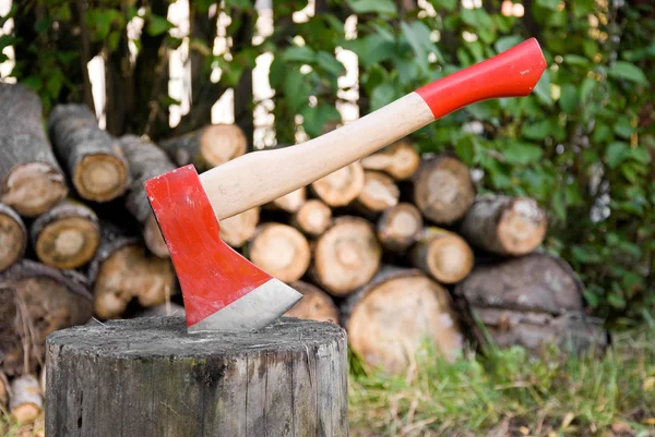 stock image Red axe for firewood chopping, log and firewood