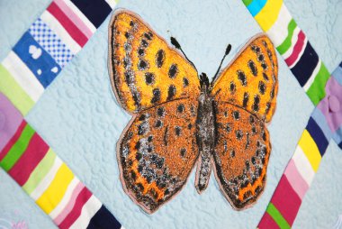 Patchwork quilt with butterflies clipart