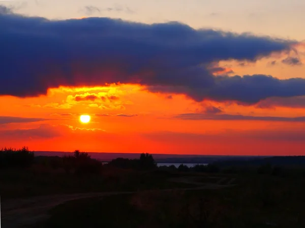 stock image Bright-red sunset with a dark cloud